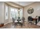 Kitchen nook breakfast area with glass table and wrought iron chairs at 26293 W Sierra Pinta Dr, Buckeye, AZ 85396