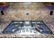 Gas cooktop with stainless steel range hood and granite countertop at 26293 W Sierra Pinta Dr, Buckeye, AZ 85396