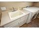 Clean laundry room features a utility sink and washer/dryer hookups at 26293 W Sierra Pinta Dr, Buckeye, AZ 85396