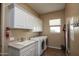 Laundry room with washer, dryer, and cabinets at 26293 W Sierra Pinta Dr, Buckeye, AZ 85396