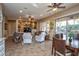 Open concept living and dining area with tile flooring and ceiling fans at 26293 W Sierra Pinta Dr, Buckeye, AZ 85396