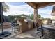 Covered patio features a built-in grill, bar seating, and fire pit at 26293 W Sierra Pinta Dr, Buckeye, AZ 85396