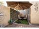 Cozy patio area with seating and umbrella for shade at 26293 W Sierra Pinta Dr, Buckeye, AZ 85396