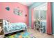 Pink and teal bedroom with twin bed and dollhouse at 2702 S Joplin --, Mesa, AZ 85209