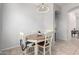 Cozy dining area with a round wooden table and four chairs, near kitchen at 2702 S Joplin --, Mesa, AZ 85209