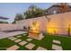 Landscaped backyard with fire pit and string lights at 2741 E Claire Dr, Phoenix, AZ 85032