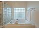 Relax in this bathroom's large soaking tub, near a glass block window at 2741 E Claire Dr, Phoenix, AZ 85032