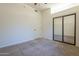 Bright bedroom with mirrored closet doors and neutral carpeting at 2741 E Claire Dr, Phoenix, AZ 85032