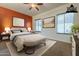 Virtually staged bedroom with two windows and orange accent wall at 2741 E Claire Dr, Phoenix, AZ 85032