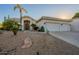 Beautiful desert landscaping surrounds this single-story home with a three-car garage at 2741 E Claire Dr, Phoenix, AZ 85032