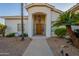 Inviting front entry with decorative wrought iron gate and a wood door at 2741 E Claire Dr, Phoenix, AZ 85032