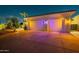 Three-car garage with decorative lighting at night at 2741 E Claire Dr, Phoenix, AZ 85032