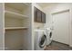 Laundry room with washer, dryer, and extra storage shelves at 2741 E Claire Dr, Phoenix, AZ 85032