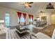 Virtually staged living room with hardwood floors and a dining area at 2741 E Claire Dr, Phoenix, AZ 85032