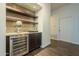 Modern wet bar with wine cooler and granite countertop at 2741 E Claire Dr, Phoenix, AZ 85032