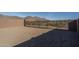 Large backyard with a block wall and mountain views at 2811 N 212Th Dr, Buckeye, AZ 85396