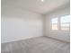 Spacious bedroom with neutral carpeting and two windows at 2811 N 212Th Dr, Buckeye, AZ 85396