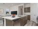 Modern kitchen island with sink, dishwasher and white countertop at 2811 N 212Th Dr, Buckeye, AZ 85396