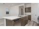 Modern kitchen island with sink, dishwasher and white countertop at 2811 N 212Th Dr, Buckeye, AZ 85396