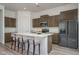 Modern kitchen with island, stainless steel appliances, and wood cabinets at 2811 N 212Th Dr, Buckeye, AZ 85396