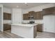 Modern kitchen with island, stainless steel appliances, and wood cabinets at 2811 N 212Th Dr, Buckeye, AZ 85396