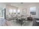 Bright living room with light gray sofas and a glass coffee table at 2811 N 212Th Dr, Buckeye, AZ 85396