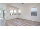 Bright living room with hardwood floors and sliding door to patio at 2811 N 212Th Dr, Buckeye, AZ 85396