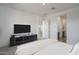 Main bedroom with a large TV and ample closet space at 2811 N 212Th Dr, Buckeye, AZ 85396