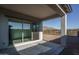 Covered patio with sliding glass doors, offering views of the desert landscape at 2811 N 212Th Dr, Buckeye, AZ 85396