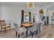 Bright dining room with wood table, gray chairs, and access to backyard at 3020 E Lark Dr, Chandler, AZ 85286