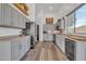 Modern kitchen with gray cabinets, stainless steel appliances, and wood flooring at 3020 E Lark Dr, Chandler, AZ 85286