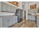 Modern kitchen with gray cabinets, stainless steel appliances, and wood flooring at 3020 E Lark Dr, Chandler, AZ 85286