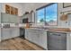 Modern kitchen with gray cabinets, stainless steel appliances, and wood flooring at 3020 E Lark Dr, Chandler, AZ 85286