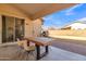 Covered patio with wooden table and chairs, backyard view at 3020 E Lark Dr, Chandler, AZ 85286