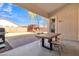 Covered patio with wooden table and chairs, overlooking backyard at 3020 E Lark Dr, Chandler, AZ 85286