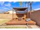 Wooden pergola with seating and fire pit in backyard at 3020 E Lark Dr, Chandler, AZ 85286