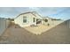 View of the backyard featuring a gravel ground covering, concrete block wall, and covered patio at 30263 W Pinchot Ave, Buckeye, AZ 85396