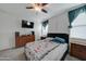 This bedroom offers a ceiling fan, carpet and window with curtains at 30263 W Pinchot Ave, Buckeye, AZ 85396