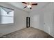 Bedroom with carpet flooring, window with blind and a closet at 30263 W Pinchot Ave, Buckeye, AZ 85396