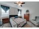 Bedroom with carpet flooring, ceiling fan, window with curtains and side tables at 30263 W Pinchot Ave, Buckeye, AZ 85396