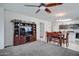 Open-concept living room featuring a large television, dining table, and kitchen at 30263 W Pinchot Ave, Buckeye, AZ 85396