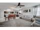 Open-concept living room featuring comfortable seating and an adjacent kitchen and dining area at 30263 W Pinchot Ave, Buckeye, AZ 85396