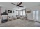 Spacious living room with neutral carpet, ceiling fan, and ample natural light at 30263 W Pinchot Ave, Buckeye, AZ 85396