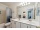 Bright bathroom boasts dual sinks and a shower-tub combination at 3102 W Louise Dr, Phoenix, AZ 85027