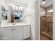 Bright bathroom featuring a large mirror, shower stall, and white cabinetry at 3102 W Louise Dr, Phoenix, AZ 85027