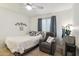 Cozy bedroom with tile floors, ceiling fan, and a gray recliner at 3102 W Louise Dr, Phoenix, AZ 85027