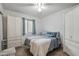 Cozy bedroom with tile floors, ceiling fan, and a closet with white louvered doors at 3102 W Louise Dr, Phoenix, AZ 85027