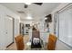 Bright kitchen and dining area features tile floors, stainless steel appliances, and glass-topped table with wood chairs at 3102 W Louise Dr, Phoenix, AZ 85027