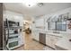 Bright kitchen with white cabinetry, modern appliances, and a view of the living area, creating a functional and social space at 3102 W Louise Dr, Phoenix, AZ 85027