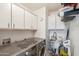 Efficient laundry room featuring modern appliances and ample cabinet space at 3102 W Louise Dr, Phoenix, AZ 85027